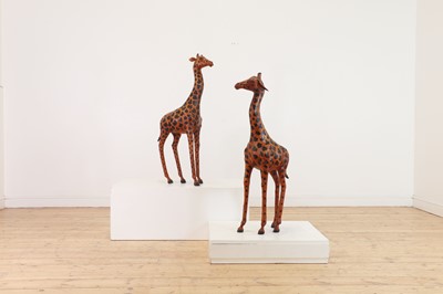 Lot 138 - A pair of painted hide figures of giraffes