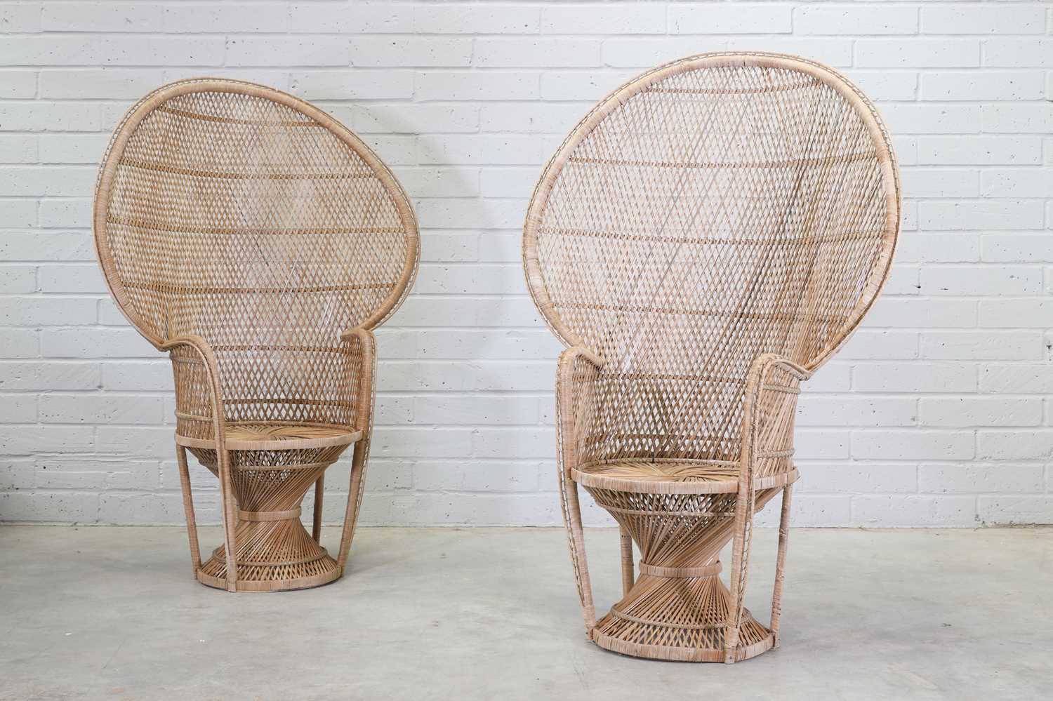 Lot 310 A pair of cane peacock chairs,