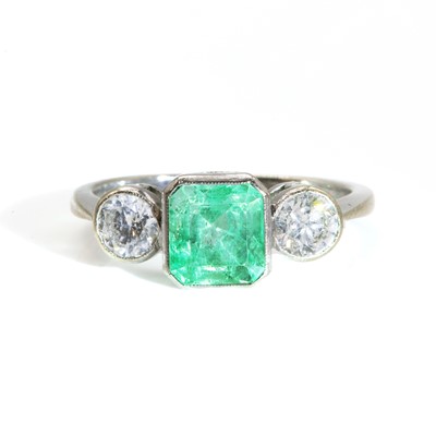 Lot 414 - A three stone emerald and diamond ring