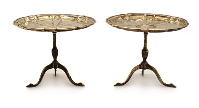 Lot 33 - A near pair of novelty silver miniature tripod tables