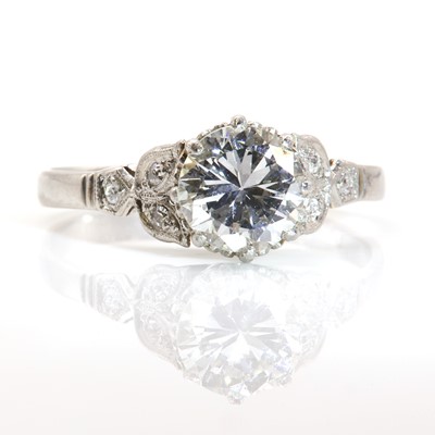 Lot 422 - A single stone diamond ring with diamond set shoulders