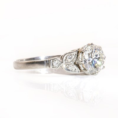Lot 422 - A single stone diamond ring with diamond set shoulders