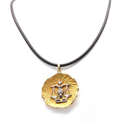 Lot 194 - A two colour gold Libra zodiac pendant, c.1970