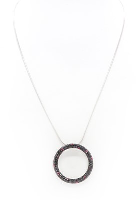 Lot 428 - An 18ct white gold dark blue sapphire and ruby 'Fantasia' pendant, by Roberto Coin