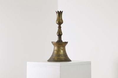 Lot 552 - An Ottoman brass tulip candlestick