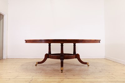 Lot 297 - A Regency-style walnut extending dining table in the manner of Johnstone, Jupe & Co.