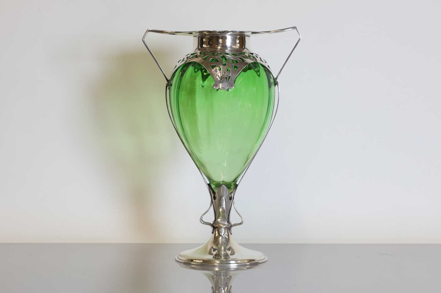 Lot 114 - An Arts and Crafts green glass and silver-mounted vase