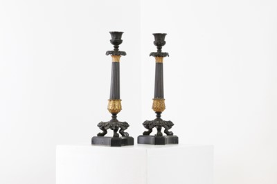 Lot 646 - A pair of Regency bronze and painted gilt candlesticks