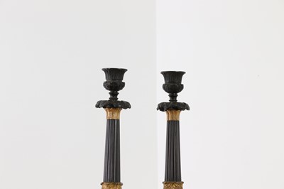 Lot 646 - A pair of Regency bronze and painted gilt candlesticks