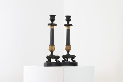 Lot 646 - A pair of Regency bronze and painted gilt candlesticks