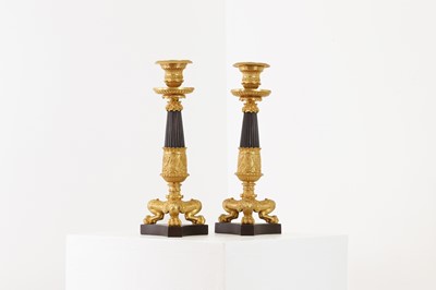 Lot 652 - A pair of Regency-style bronze and parcel-gilt candlesticks