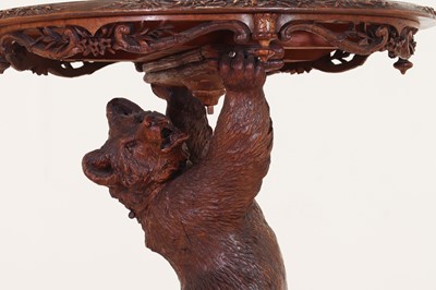 Lot 634 - A Black Forest carved wood occasional table
