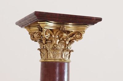 Lot 650 - A pair of rouge marble pedestals