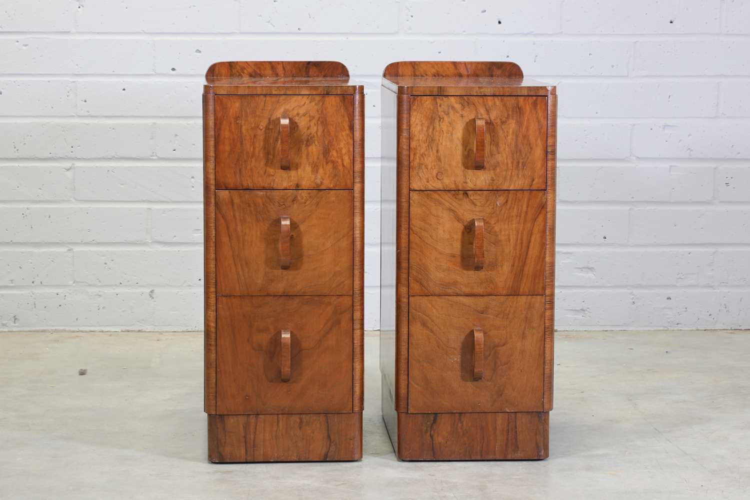 Lot 210 A pair of Art Deco walnut bedside tables,