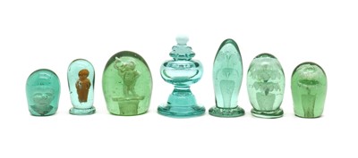 Lot 140 - A group of six Victorian bottle green glass dump weights