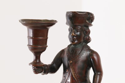 Lot 167 - A bronze figural candlestick
