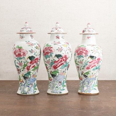 Lot 155 - A set of three Chinese famille rose vases and covers