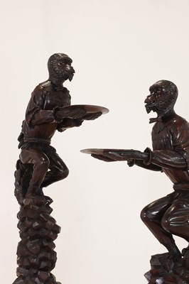 Lot 165 - A pair of large carved walnut monkey waiters