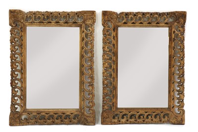 Lot 407 - A pair of Moorish style carved wooden mirrors