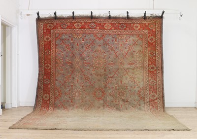Lot 381 - An Oushak wool carpet of Agra design