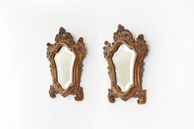 Lot 571 - A pair of baroque-style parcel-gilt wall mirrors