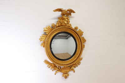 Lot 544 - A Regency carved giltwood convex mirror