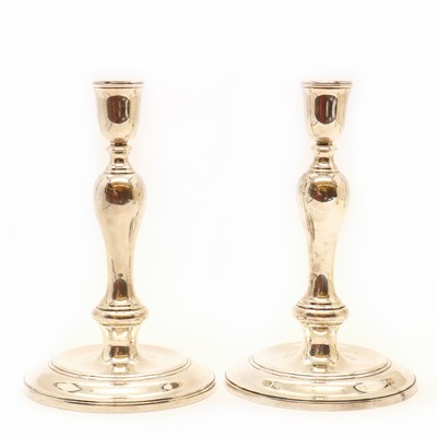 Lot 102 - A pair of silver candlesticks