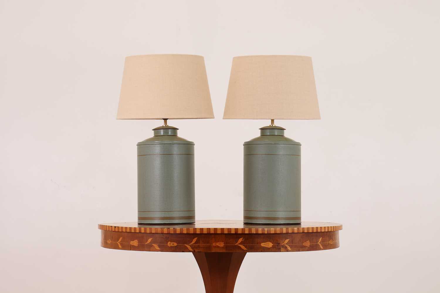 Lot 353 - A pair of painted toleware 'Camellia' table lamps by OKA