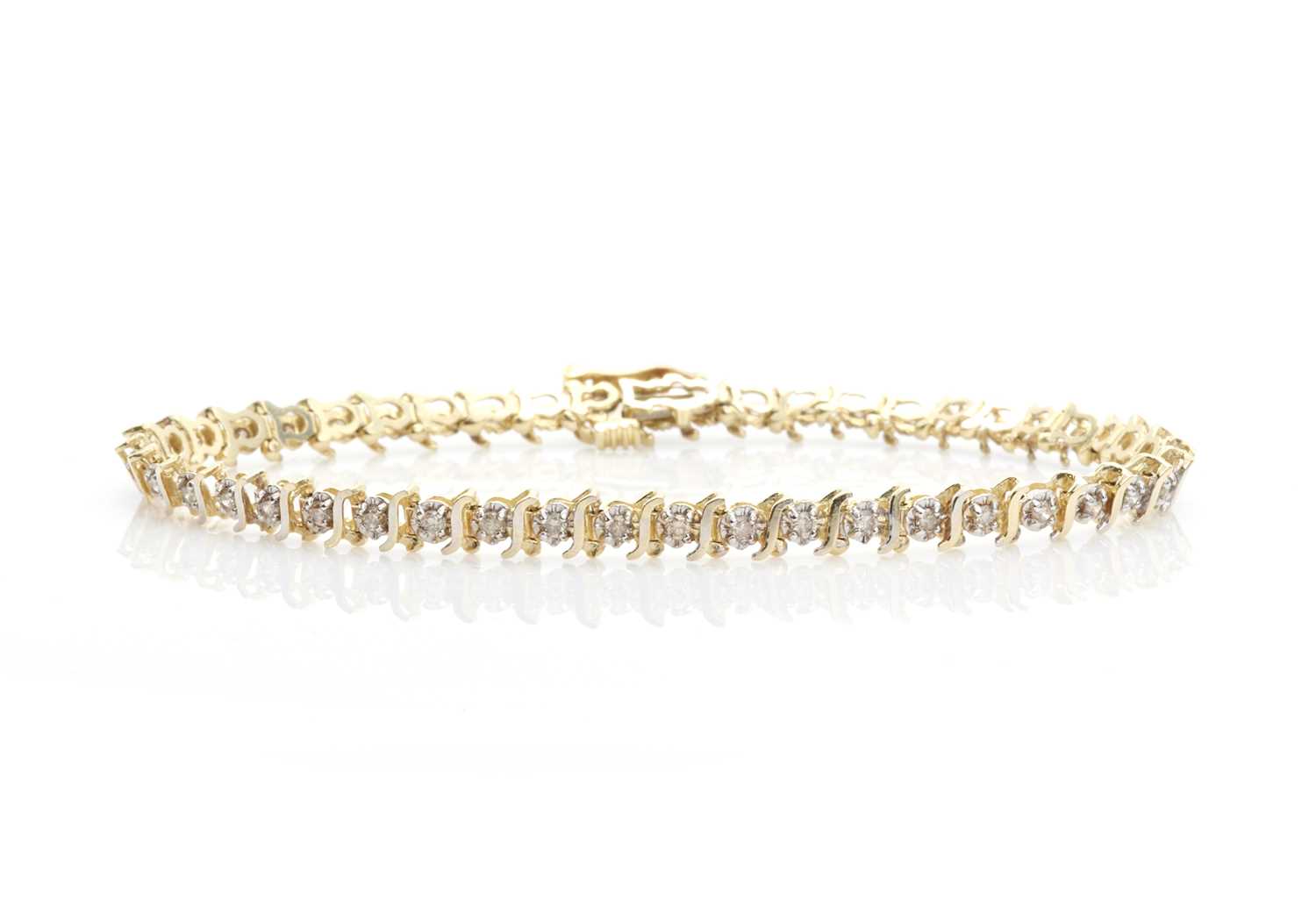 Lot 242 - A diamond set line bracelet,