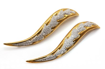 Lot 129 - A pair of Continental diamond set two colour gold flame or leaf brooches