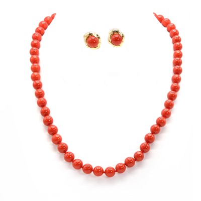 Lot 311 - A single row uniform coral bead necklace and a matched pair of coral stud earrings