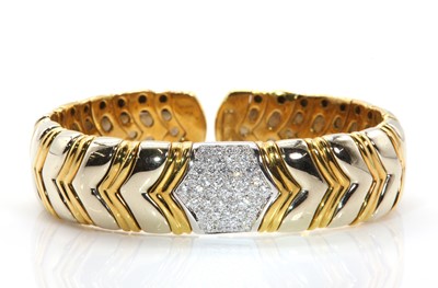 Lot 287 - An Italian two colour gold diamond set sprung bangle