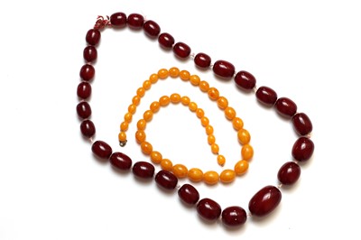 Lot 239 - A single row cherry red faux amber bead necklace