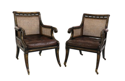 Lot 333 - A pair of Regency-style ebonised and parcel gilt bergères