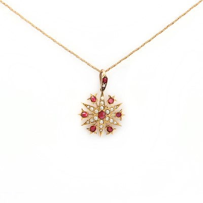 Lot 14 - A late Victorian gold synthetic ruby and split pearl starburst pendant