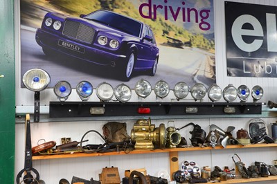 Lot 25 - A mounted display of early motoring lamps
