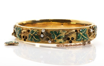 Lot 51 - A Russian enamel and seed pearl gold hinged bangle, c.1848