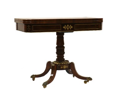Lot 333 - A Regency rosewood brass strung fold-over card table