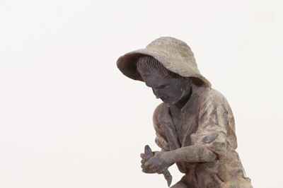 Lot 657 - A lead figure of a young fisherman