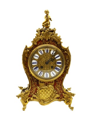 Lot 149 - A red boulle mantel clock