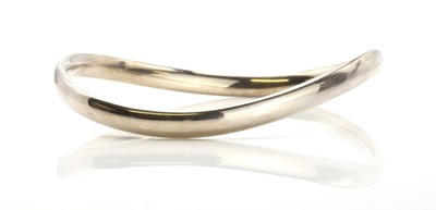 Lot 443 - A sterling silver slave bangle by Georg Jensen