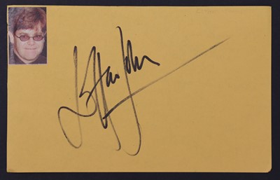 Lot 147 - Elton John: autograph on yellow paper