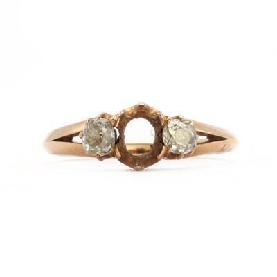 Lot 62 - A rose gold three stone diamond ring, with a vacant collet