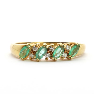 Lot 104 - An 18ct gold emerald and diamond half eternity ring