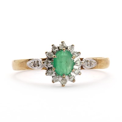 Lot 102 - A 9ct gold emerald and diamond cluster ring