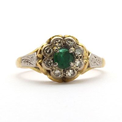 Lot 103 - A two colour gold emerald and diamond floral cluster ring