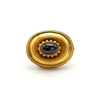 Lot 7 - A Victorian gold and garnet oval shield brooch