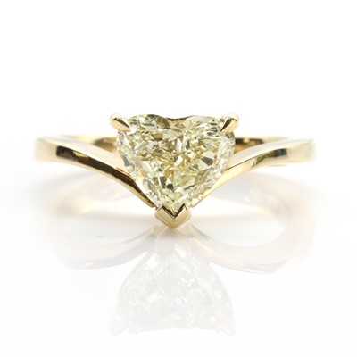 Lot 380 - A heart-shaped fancy light yellow diamond ring, †