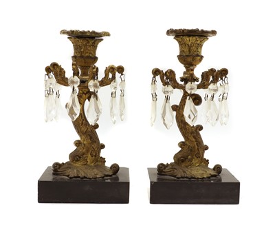 Lot 334 - A pair of Regency gilt metal candlesticks