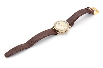 Lot 416 - A gold Movado mechanical strap watch